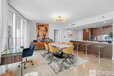 A modern dining room with a large table and chairs.