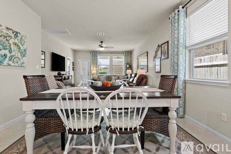 A dining room with a table set for four.