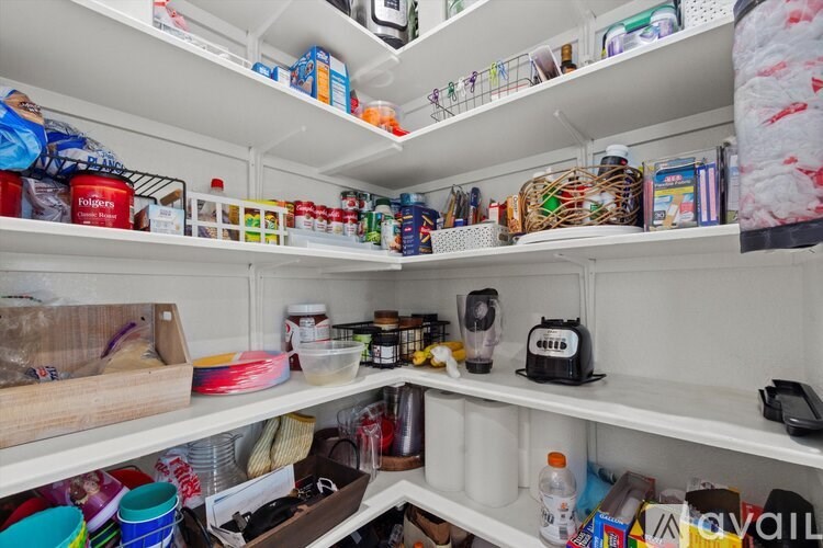 A white refrigerator is full of food and drinks.