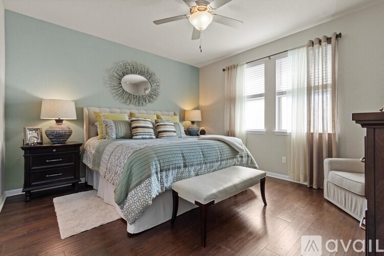 A bedroom with a bed, nightstand, and a bench.