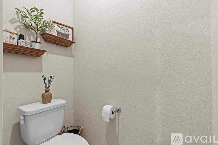 A white toilet with a wooden container on top of it.