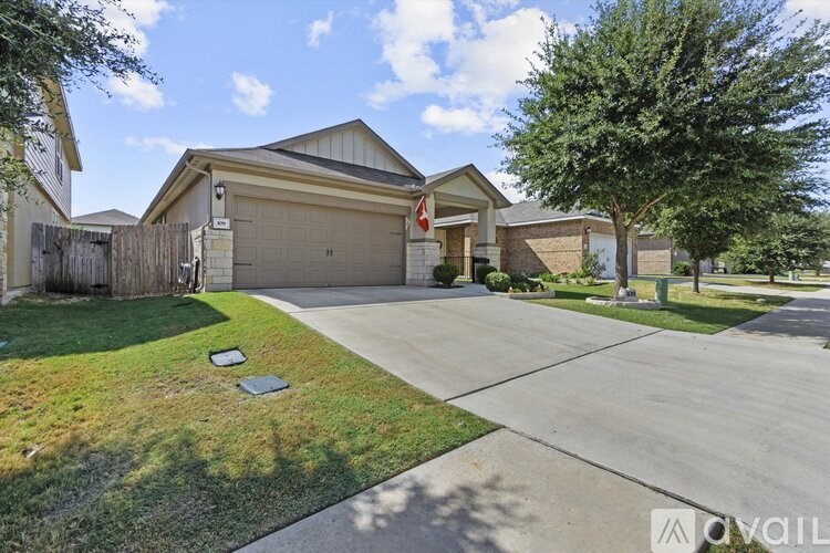 A house with a garage and a driveway is for sale.