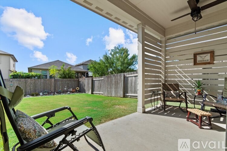 A patio with a chair and a table is shown.