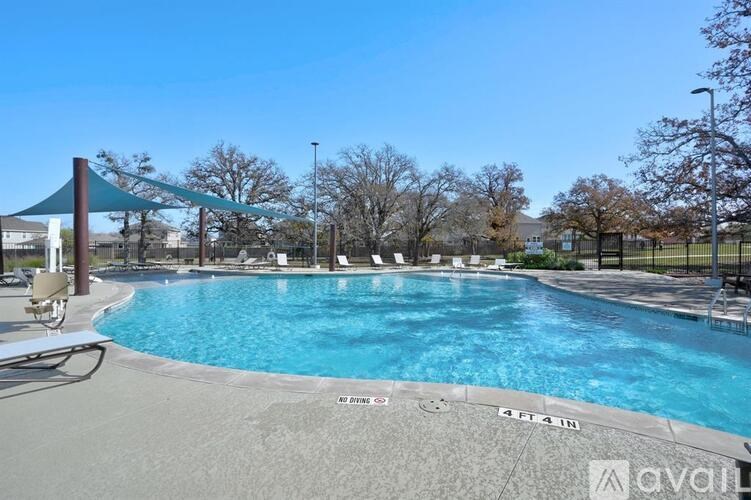 A large swimming pool with a blue sky in the background.