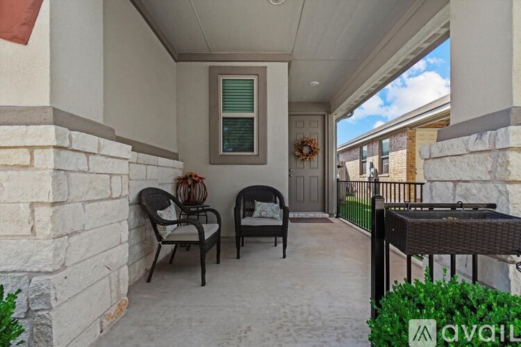 A patio with two chairs and a table.