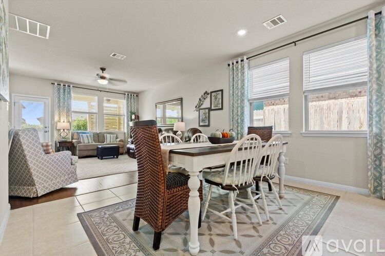 A dining room with a table set for four.