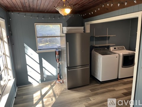 A kitchen with a stainless steel refrigerator and a white dishwasher.