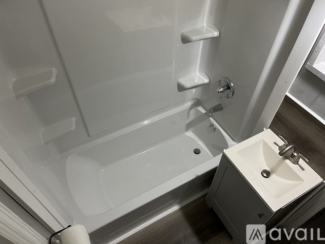 A white bathroom with a tub and sink.