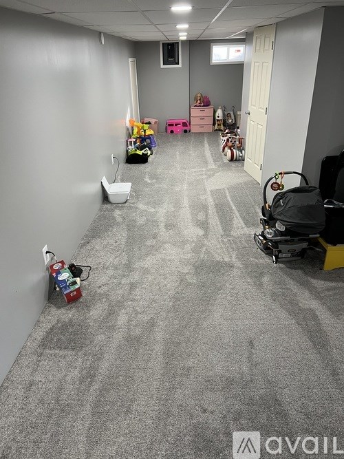 A long hallway with a lot of toys on the floor.