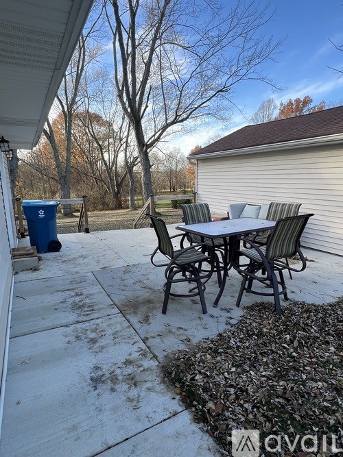 A patio with a table and chairs is shown.