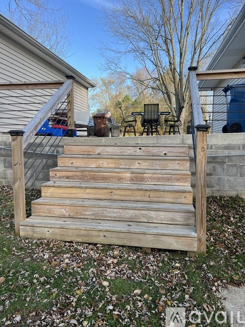 A wooden staircase leads up to a house.