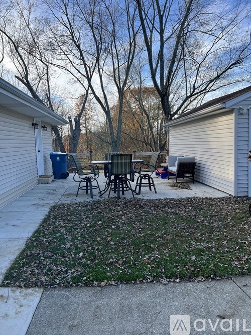 A backyard with a table and chairs.