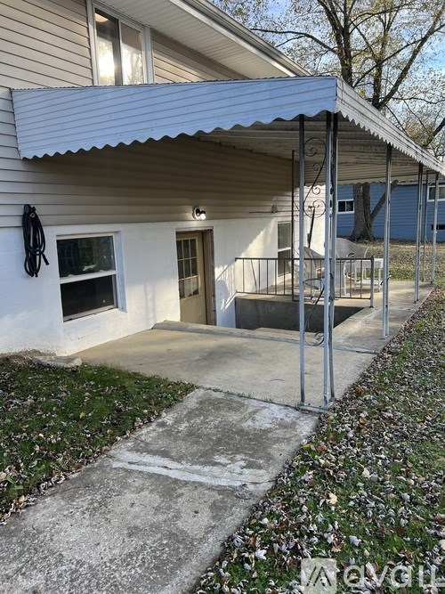 A house with a white door and a small window is shown.