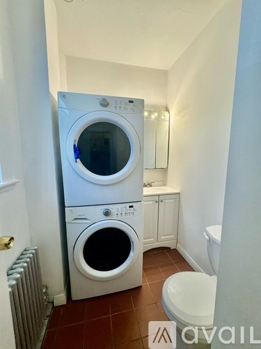 A white washing machine and dryer in a small laundry room.