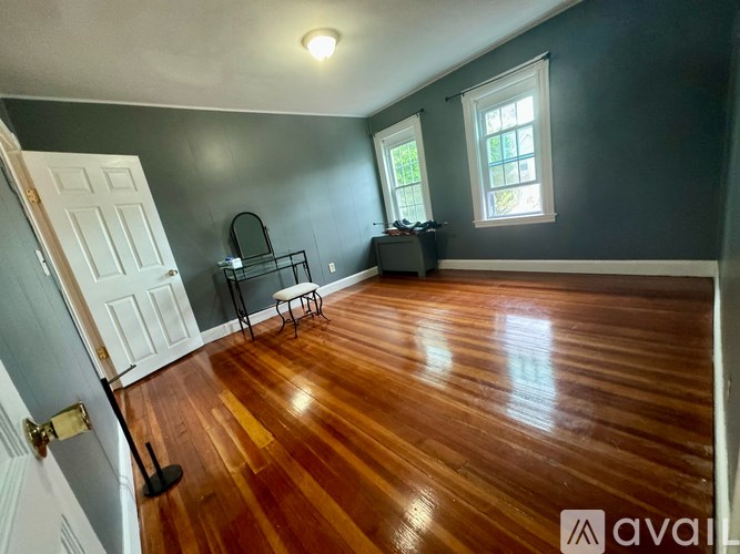A room with wooden floors and a white door.