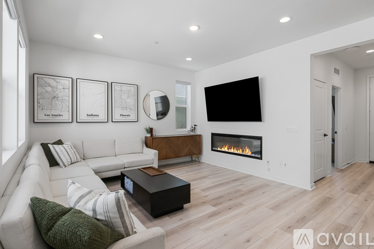 A modern living room with a fireplace and a flat screen TV.