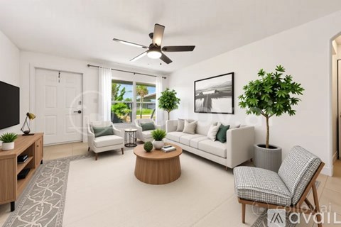 A living room with a white couch, a coffee table, and a ceiling fan.