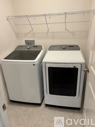 Two white ovens are in a small room.