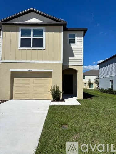 A two-story house with a garage is shown in the image.