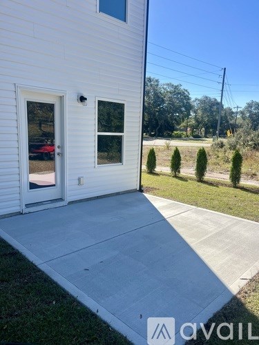 A white house with a porch and a window.
