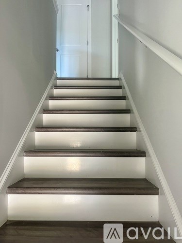 A set of stairs with lights underneath them.