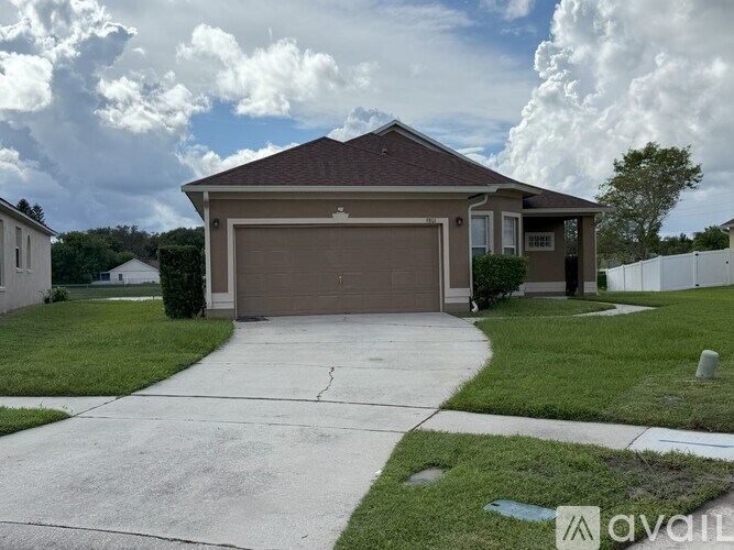 A house with a brown garage door is for sale.