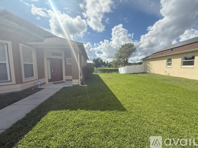 A sunny day at a residential area with houses and green lawns.