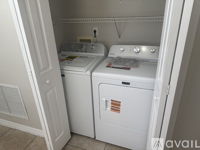 A small laundry room with a washer and dryer.