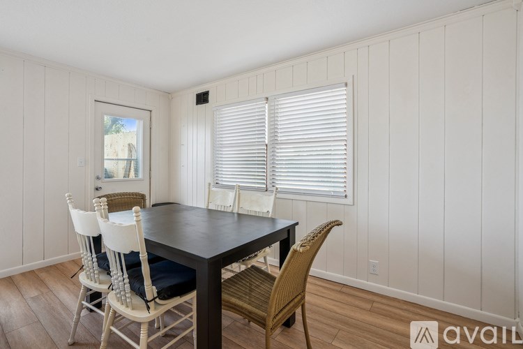 A dining room with a table and chairs.