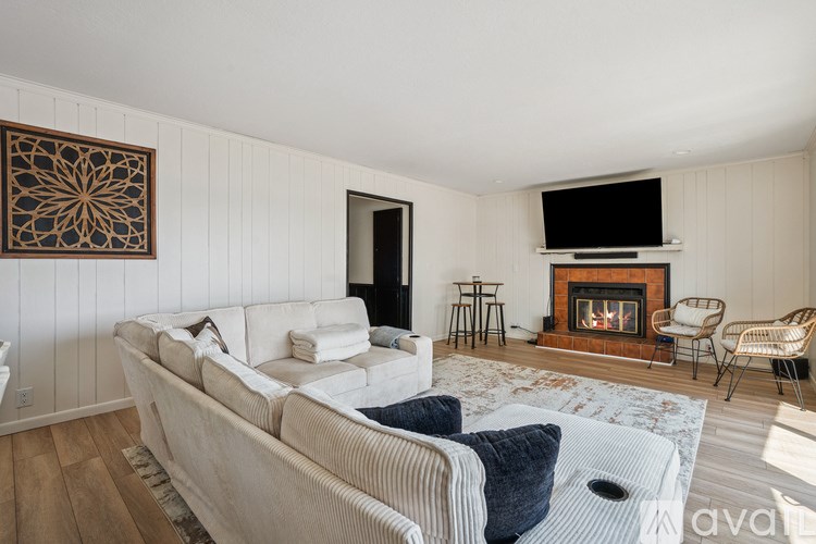A living room with a fireplace and a television.