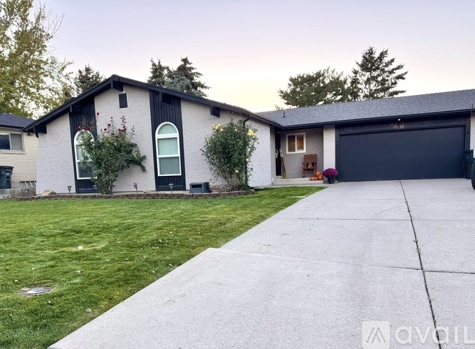 A house with a grey roof and a white garage door.