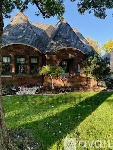 A house with a red brick exterior and a grey roof.