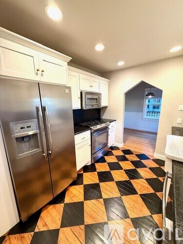 A kitchen with a black and white checkered floor.