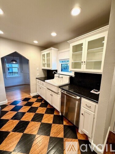 A kitchen with black and white checkered floor.