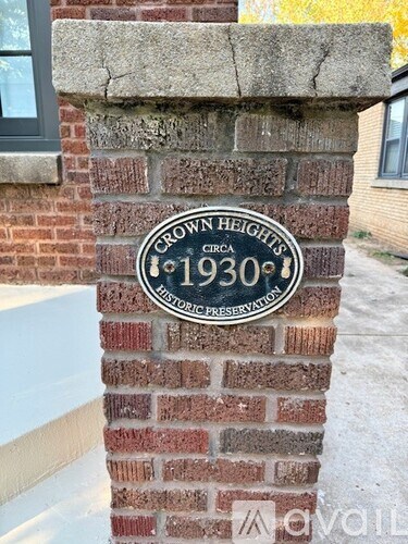 A sign on a brick pillar that says Crown Heights 1930.