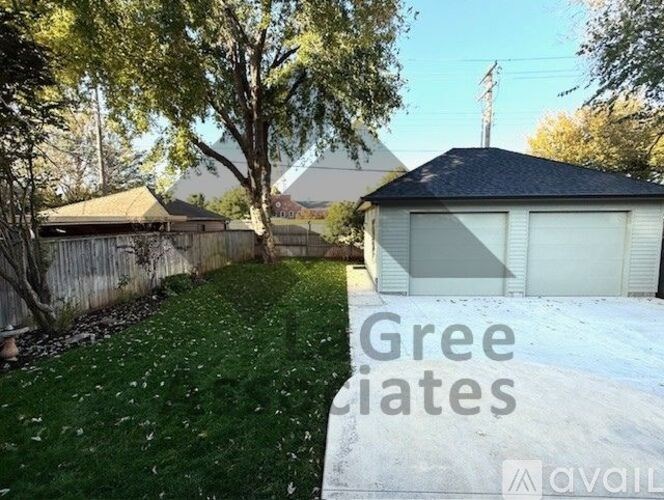 A house with a white garage door is for sale.