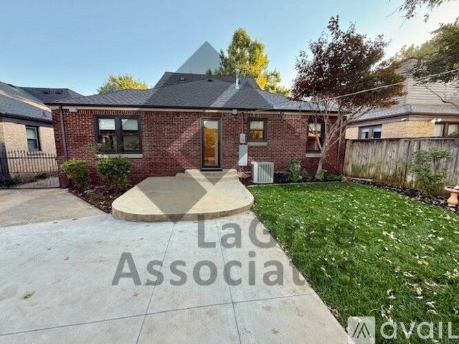 A house with a brick facade and a large front yard.