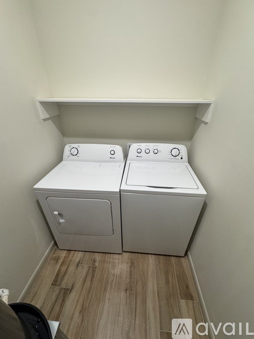 A small laundry room with a washer and dryer.