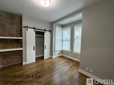 A room with a brick wall and a sliding door.