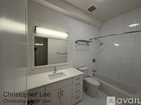 A white bathroom with a sink, toilet, and bathtub.