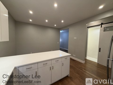 A kitchen with white countertops and cabinets is available for rent.