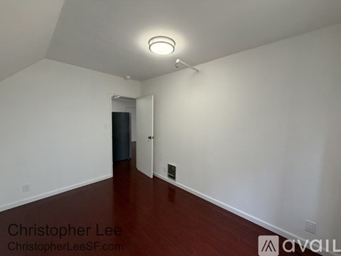 A room with white walls and a wooden floor.