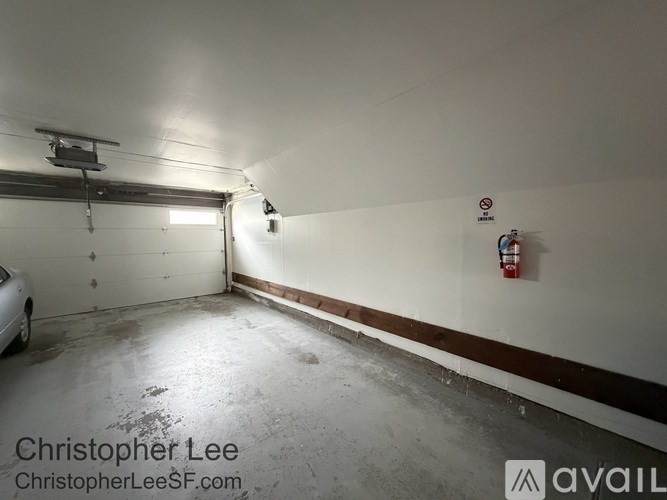 A garage with a white car parked in it.