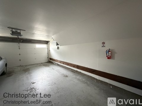 A garage with a white car parked in it.