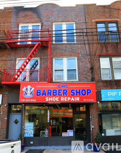 A red fire escape on a brick building.