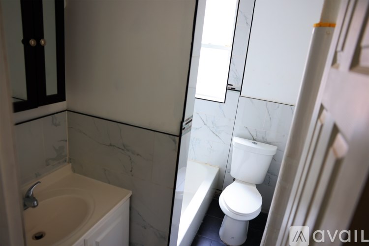 A bathroom with a sink, toilet and bathtub.