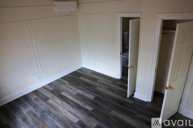 A room with a wooden floor and white walls.