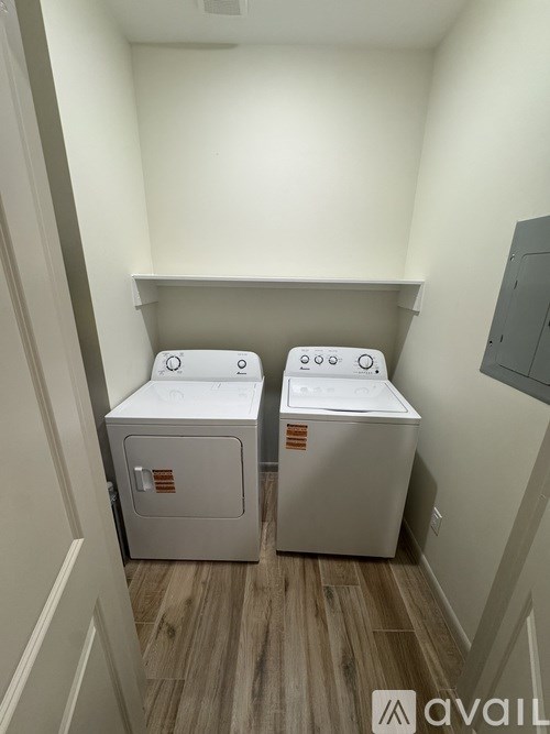Two washing machines in a small laundry room.