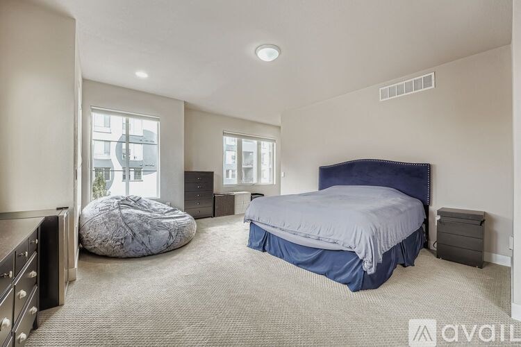 A bedroom with a round bed and a window overlooking a cityscape.