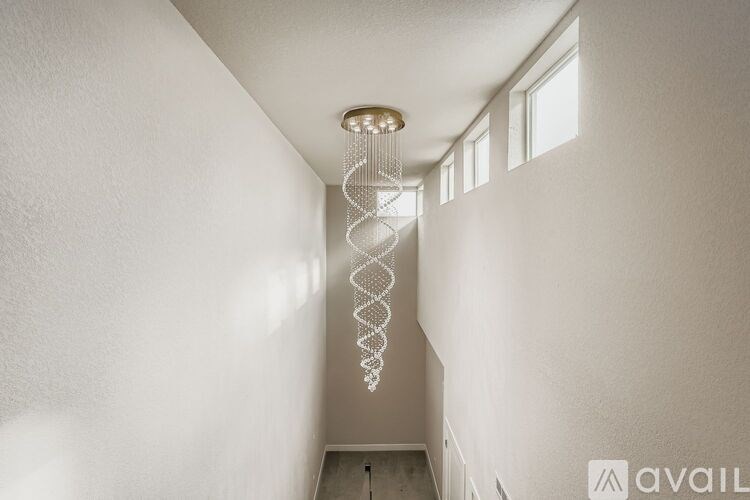 A white spiral staircase with a light on top.